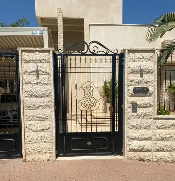 שער הולכי רגל צר עם עיטור פליז ולוח מלא בתחתית